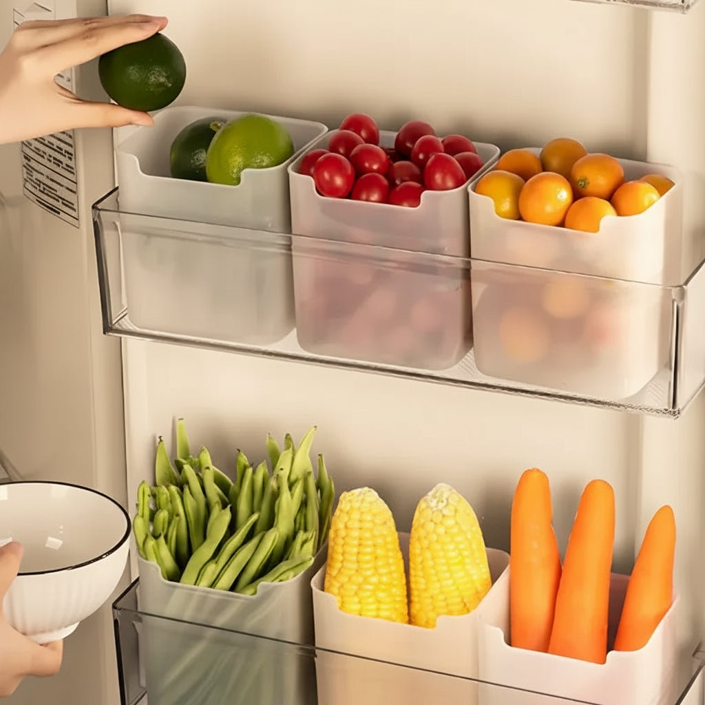 Fruit and vegetable storage bins inside a refrigerator with fresh produce.